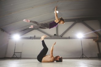 The theme of Acroyoga and Yoga Poses. Acroyogis practicing. with studio Backlight. the Base man