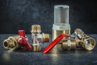 Set of brass pipe connectors ondark background
