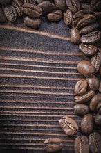 Heap of coffee beans on vintage wooden board