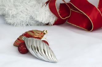 Christmas motifs with balls and chains. Red and white balls, white chains and red ribbon