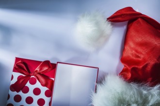 Santa cap wrapped present box on white background