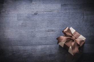 Packed gift box-container on vintage wood board holiday concept