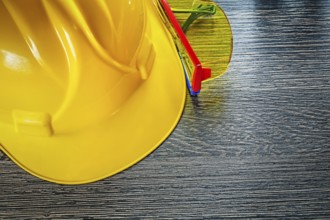 Safety cap plastic goggles on wooden board