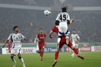 Fabio Baldé (HSV) leaps over a header by Michael Gregoritsch (SC Freiburg) during the match for the