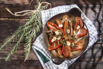 Dried tomatoes with olive oil, rosemary and garlic