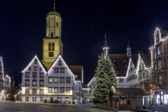 Night photo of historic buildings around the market square with Christmas tree and Christmas lights