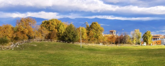 Bansko, Bulgaria autumn panorama banner background with colorful green, red and yellow trees, Rila