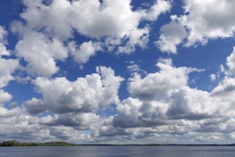 Blue sky with white to grey clouds over the Plöner See in Schleswig-Holstein. These are cumulus