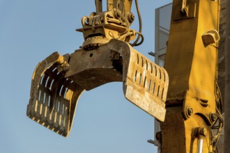 Excavators on a building site demolishing a house, creating space for new flats and living space