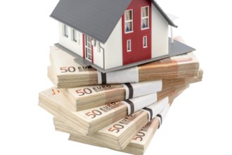 House on euro banknotes, symbolic photo for house purchase, financing, building society savings