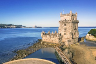 Drone shot of Belem tower landmark, Lisbon, Portugal at blue summer day sky. Medieval fortification