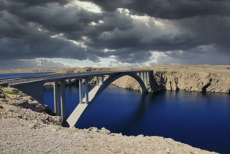 Impressive bridge spans a river under a dramatic, cloudy sky, Pag Bridge, Pag, Dalmatia, Croatia,