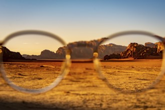 View at the Wadi Rum desert in Jordan through glasses during a nice sunset with clear sky. Travel,