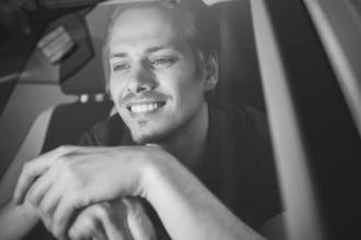 Enjoy the drive. Image of young handsome guy sitting in car