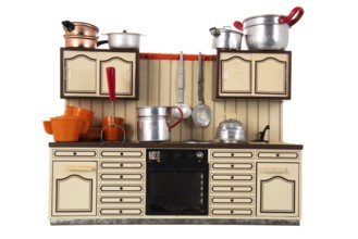 Miniature vintage toy kitchen with utensil isolated over white background