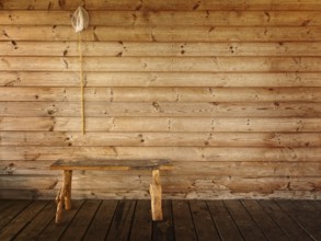 Butterfly net and bench against wooden wall