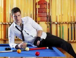 Billiard handsome player man drinking some alcohol in club