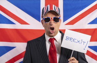 British male businessman with Brexit banner and UK flag