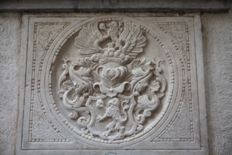 Coat of arms, stone relief on a gravestone, exterior facade of the cathedral, Graz, Styria,