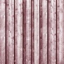 Close-up view of weathered wooden planks creating a rustic red background.Belarus
