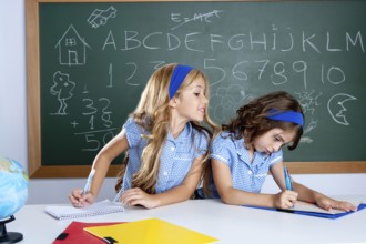 Classroom with two kids students cheating on test exam at school