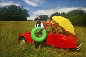 Typical French man is going to the beach with his typical classic car