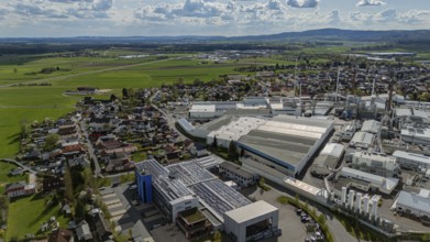 Industrial building scene next to a cityscape with a wide view of fields and sky, Mitterteich,