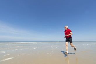Elder man running at the beach