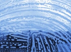 Soap foam bubbles on the glass