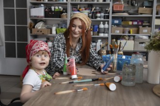 A delightful art session where a mother and child engage in creative activities, showcasing bonding