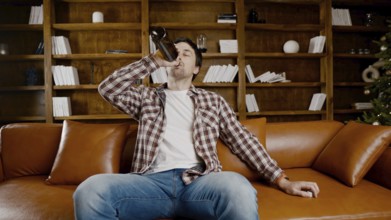 Alcohol addiction at young age. Caucasian male cannot stop drinking alcohol, drunken lonely male