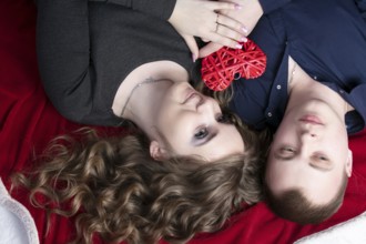 Couple in love from top to bottom. Man and woman with a red heart. Beautiful young man and woman