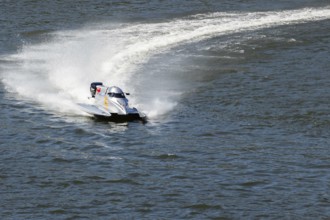 PESO DA REGUA, PORTUGAL - SEPTEMBER 15, 2024: Gray Powerboat Making Turn with Splashes of Water