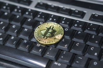 Background with bitcoin on the keyboard