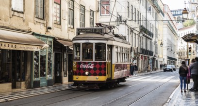 Lisbon, Portugal, 12 28 2018: Typical tramway driving in downtown Bairro Chiado in the steep narrow