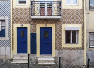 Lisbon, Portugal, 12 28 2018: Typical Portuguese facade with tiles and two small blue doors, Europe