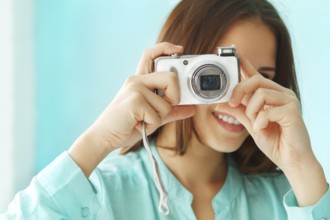 Close up portrait of a beautiful cute teen girl with digital photo camera