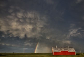 Abandoned Farm with storm clouds in the Canadian Prairie