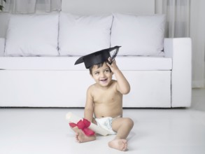 Baby holding degree certificate, MR#779O