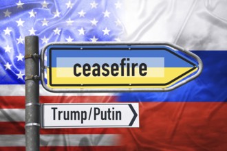 Signpost with lettering ceasefire on national colours of Ukraine in front of flag of the USA and