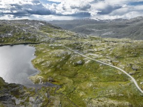 Typical landscape in norway with high snow covered mountains and deep lakes