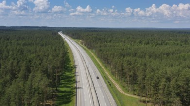 Aerial top view landscape with a country road in the forest at summer