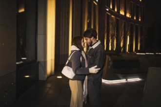 A couple shares an intimate moment, forehead to forehead, at night