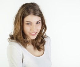 Portrait of pretty young woman against white background, Belgium, Europe
