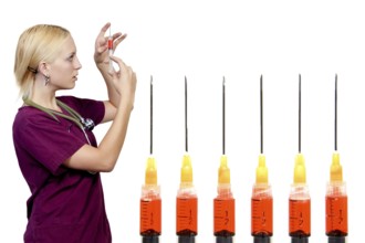 A beautiful blonde woman medical doctor preparing an injection in a syringe