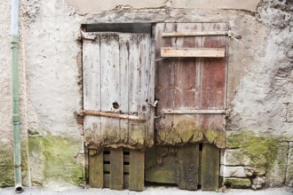 Very old wooden rotten doors in French building