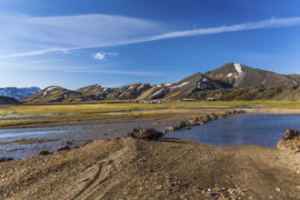 Camping site with cars and tents in a valley on July 09, 2013 in Landmannalaugar, Iceland, Europe
