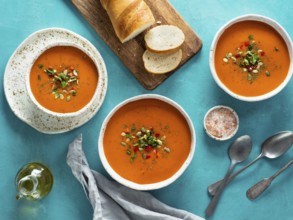 Gaspacho soup on blue tabletop. Three bowls of traditional spanish cold soup puree gaspacho or