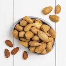 Almond on white wooden background