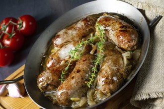 Homemade white sausage fried with onion and herbs